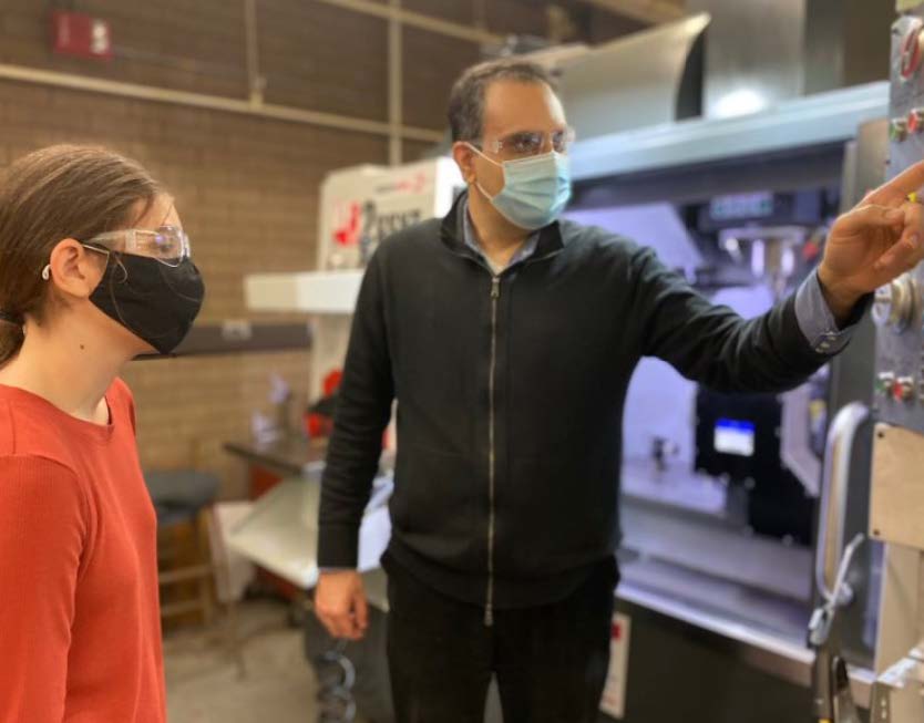 Dr. Siamak Farhad (right) is training UA student, Michala Dauterman, (left) on a CNC machine.